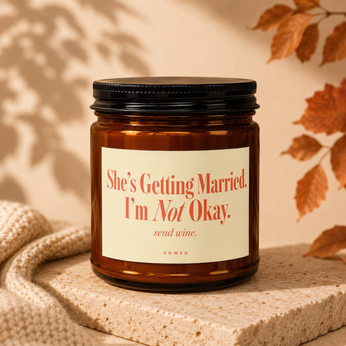 Brown glass candle with "She's Getting Married. I'm Not Okay. send wine." text.