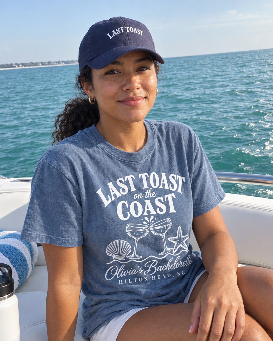 Navy embroidered Last Toast dad cap on a boat