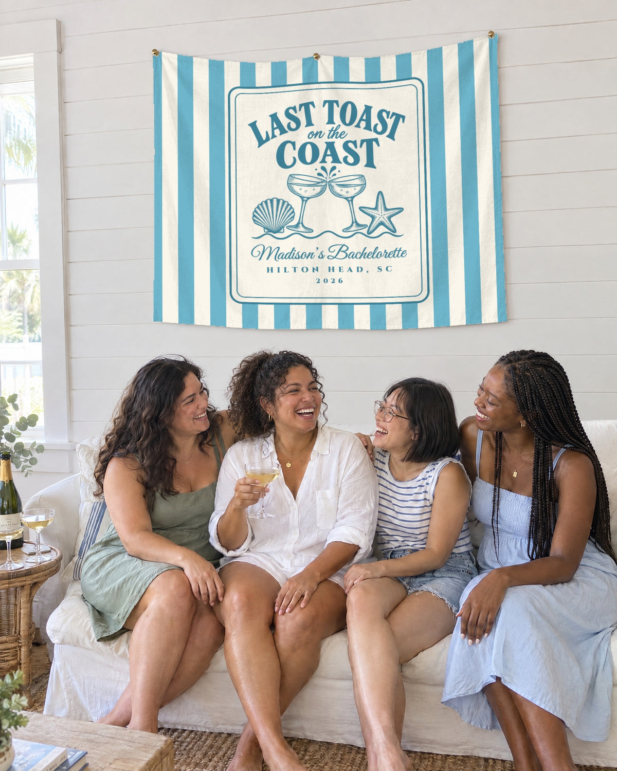 Last Toast On The Coast wall tapestry hanging above the crew on a sofa