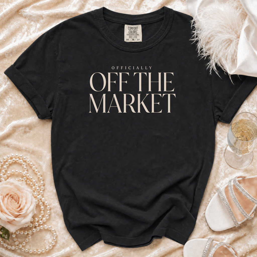 Black t-shirt with "OFFICIALLY OFF THE MARKET" text, draped on fabric.
