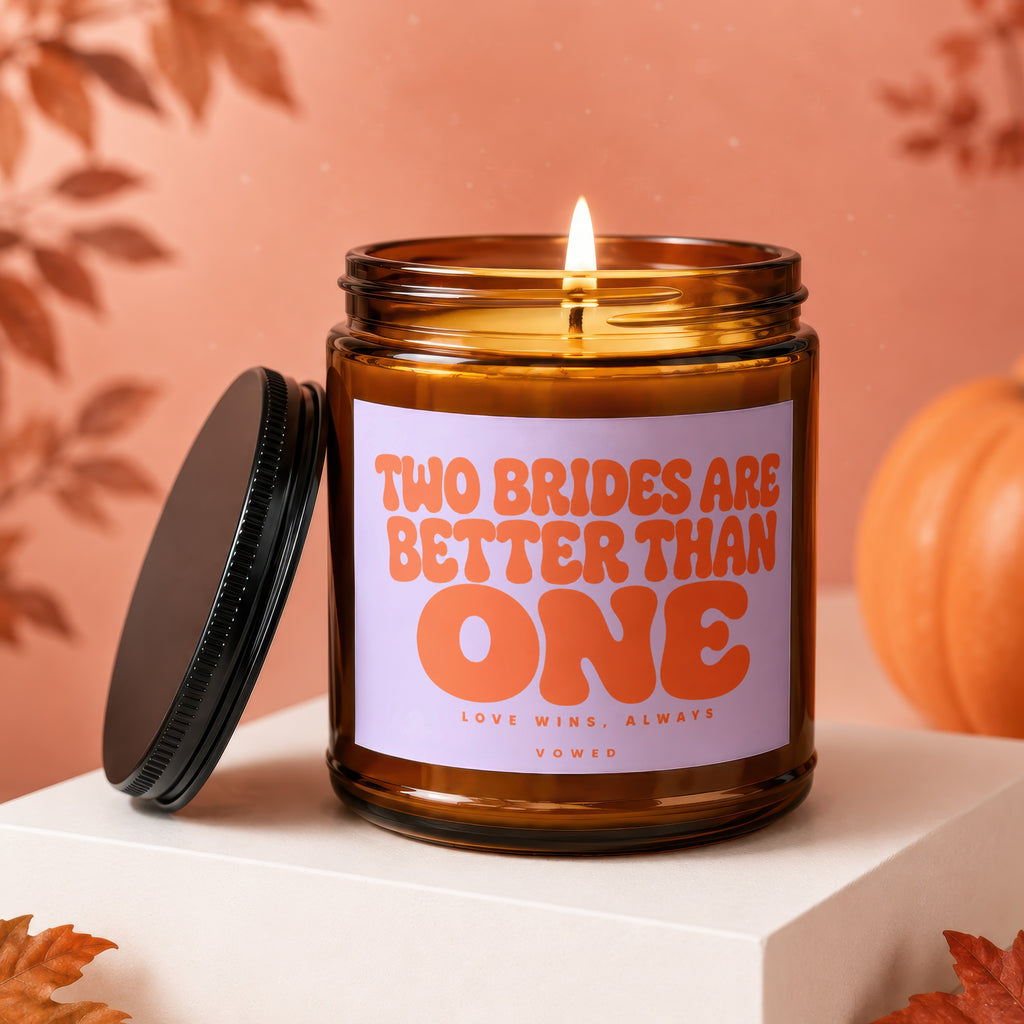 Amber candle with lid, displaying "TWO BRIDES ARE BETTER THAN ONE" text.