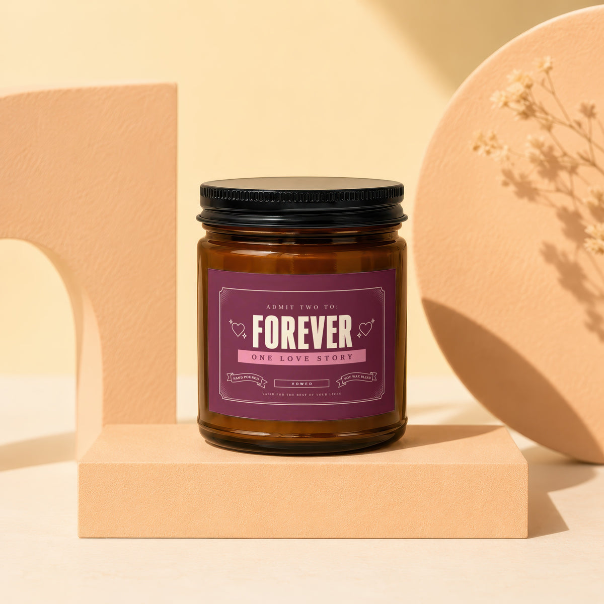 Brown glass candle with "Forever One Love Story" label on a peach block.