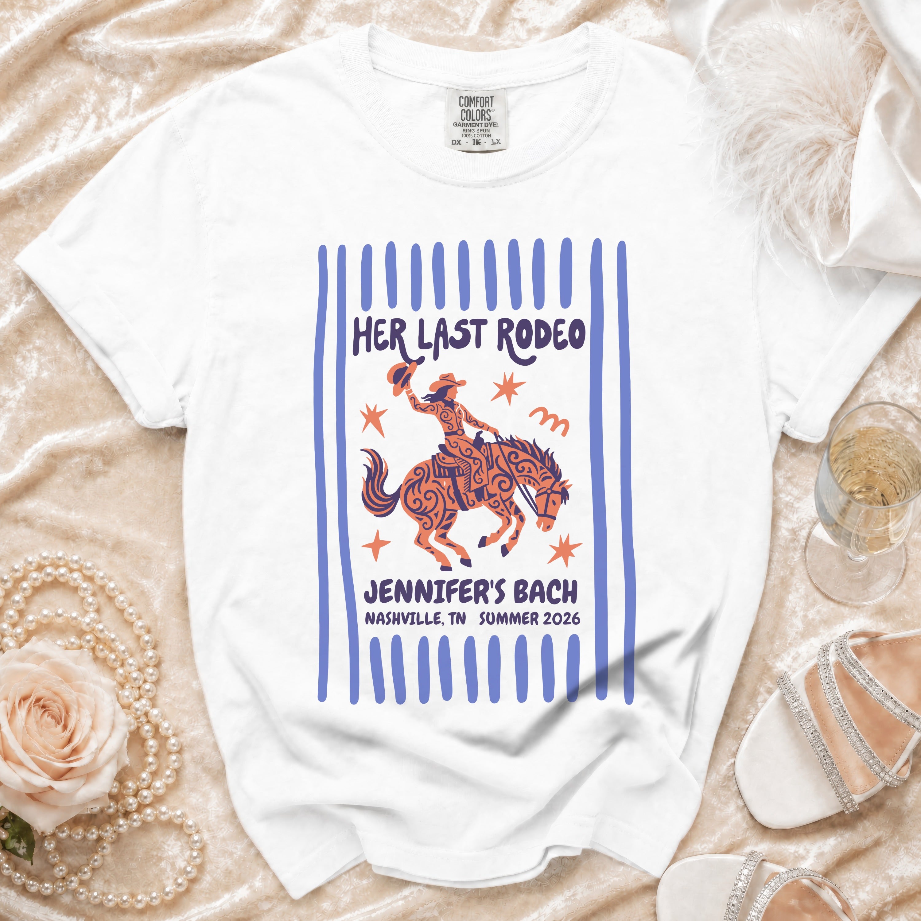 White t-shirt with "Her Last Rodeo" graphic, a cowgirl on a horse.