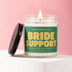 Glass candle labeled "BRIDE SUPPORT OPEN TWENTY-FOUR HOURS. STAFF OF ONE. VOWED"