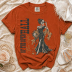 Orange t-shirt with skeleton woman, pumpkins, and text "OF THE OPERA HALL Boo-tiful".