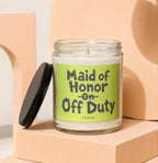 Glass candle with "Maid of Honor on Off Duty. VOWED." text on a light green label.