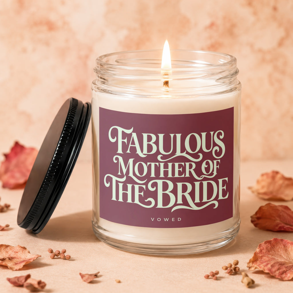 Lit candle in jar with "Fabulous Mother of the Bride" text and lid off.