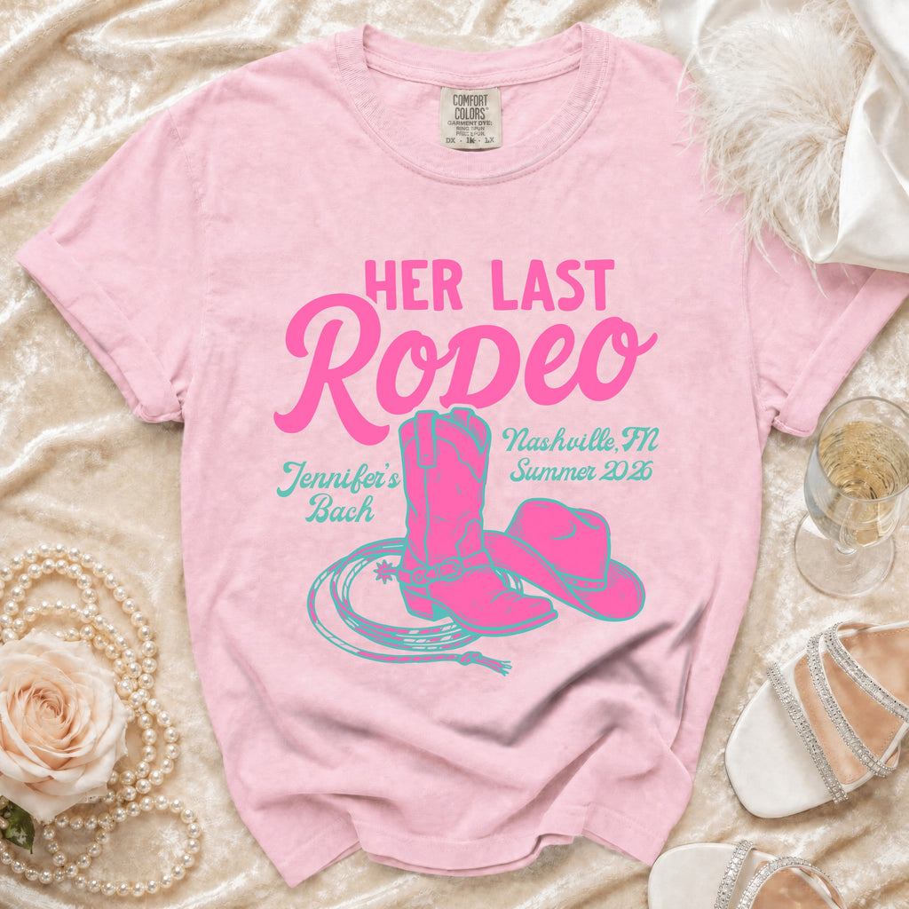 Pink t-shirt with "Her Last Rodeo" text, cowboy boot, hat, and lasso design.