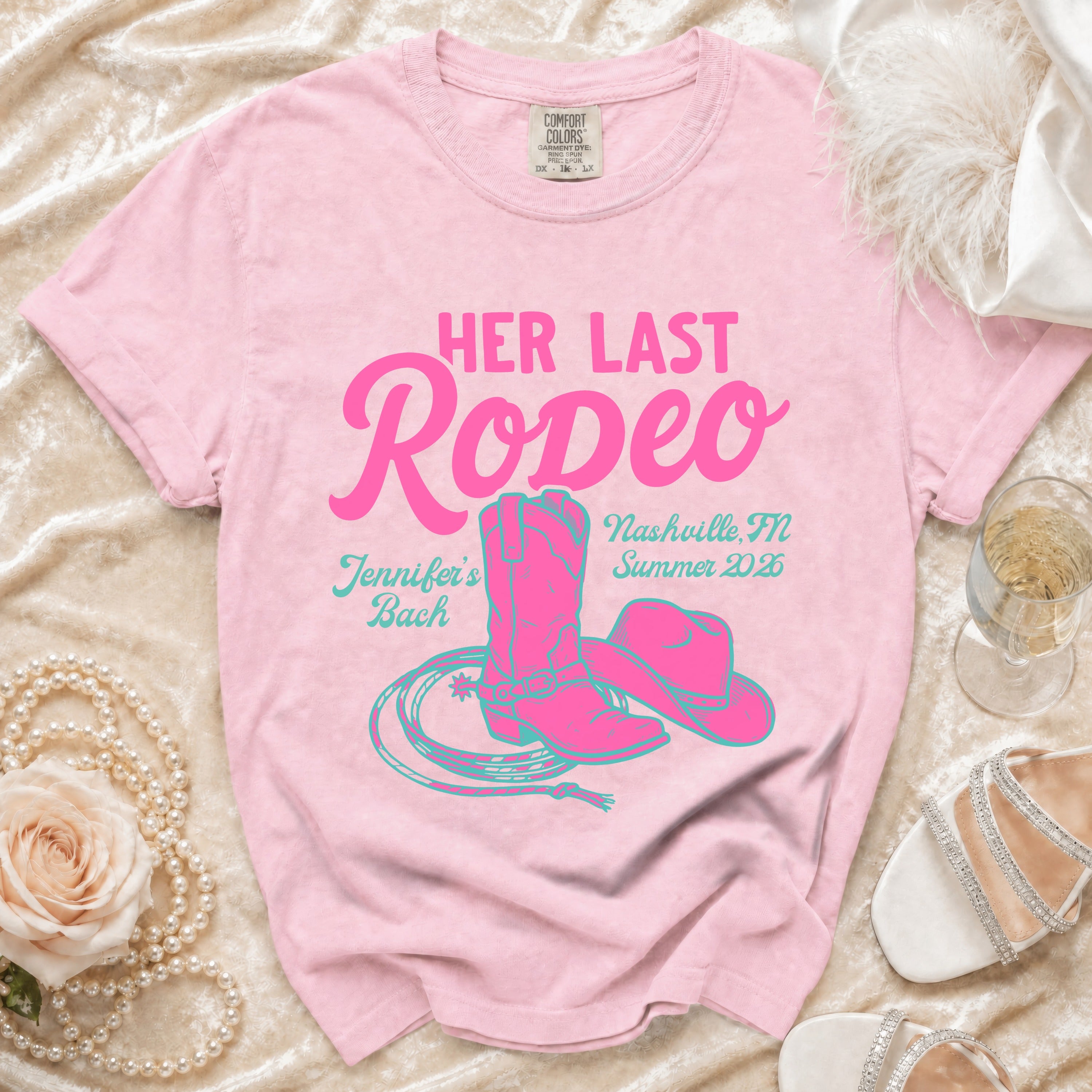 Pink t-shirt with "Her Last Rodeo" text, cowboy boot, hat, and lasso design.