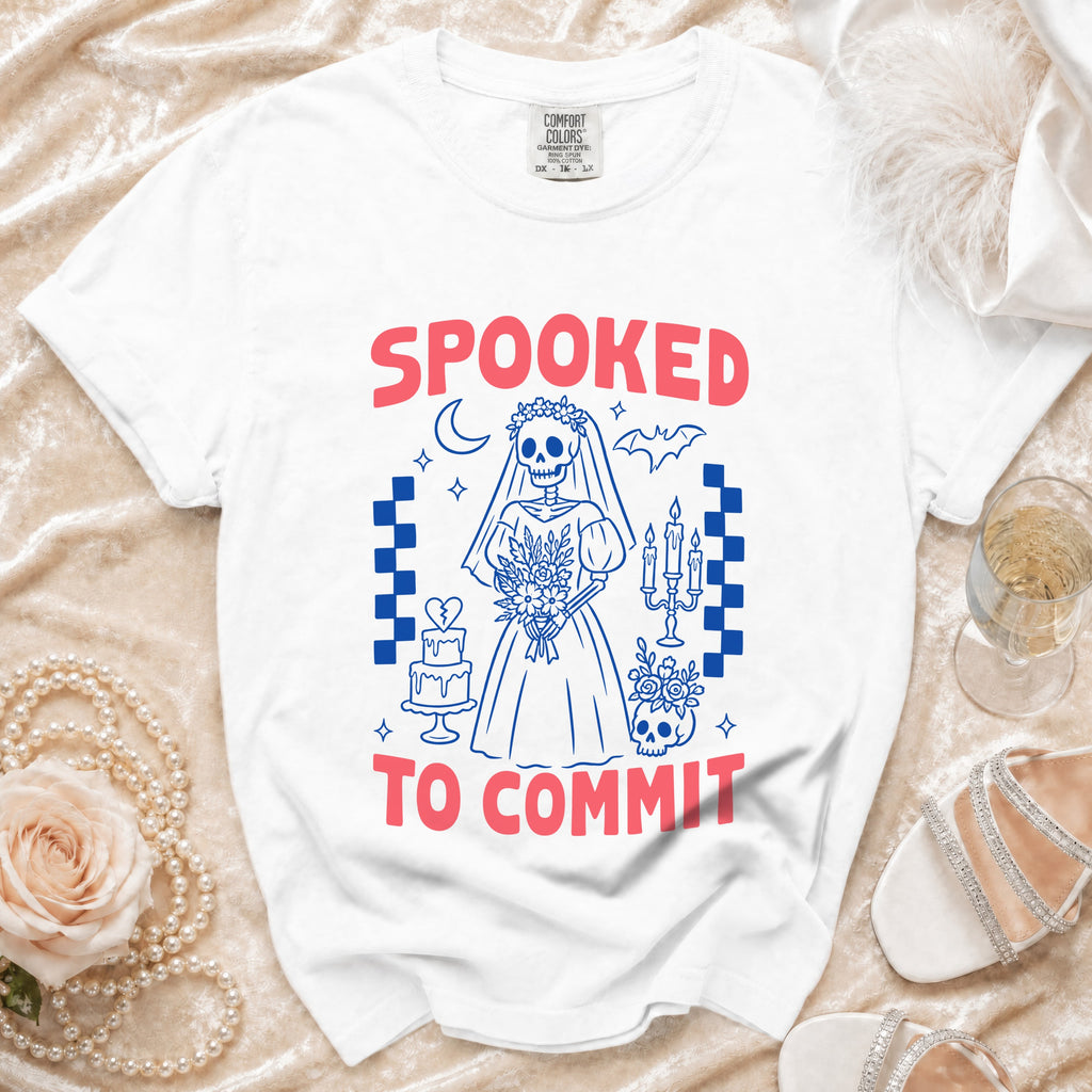 White t-shirt with "Spooked to Commit" text and skeleton bride graphic.