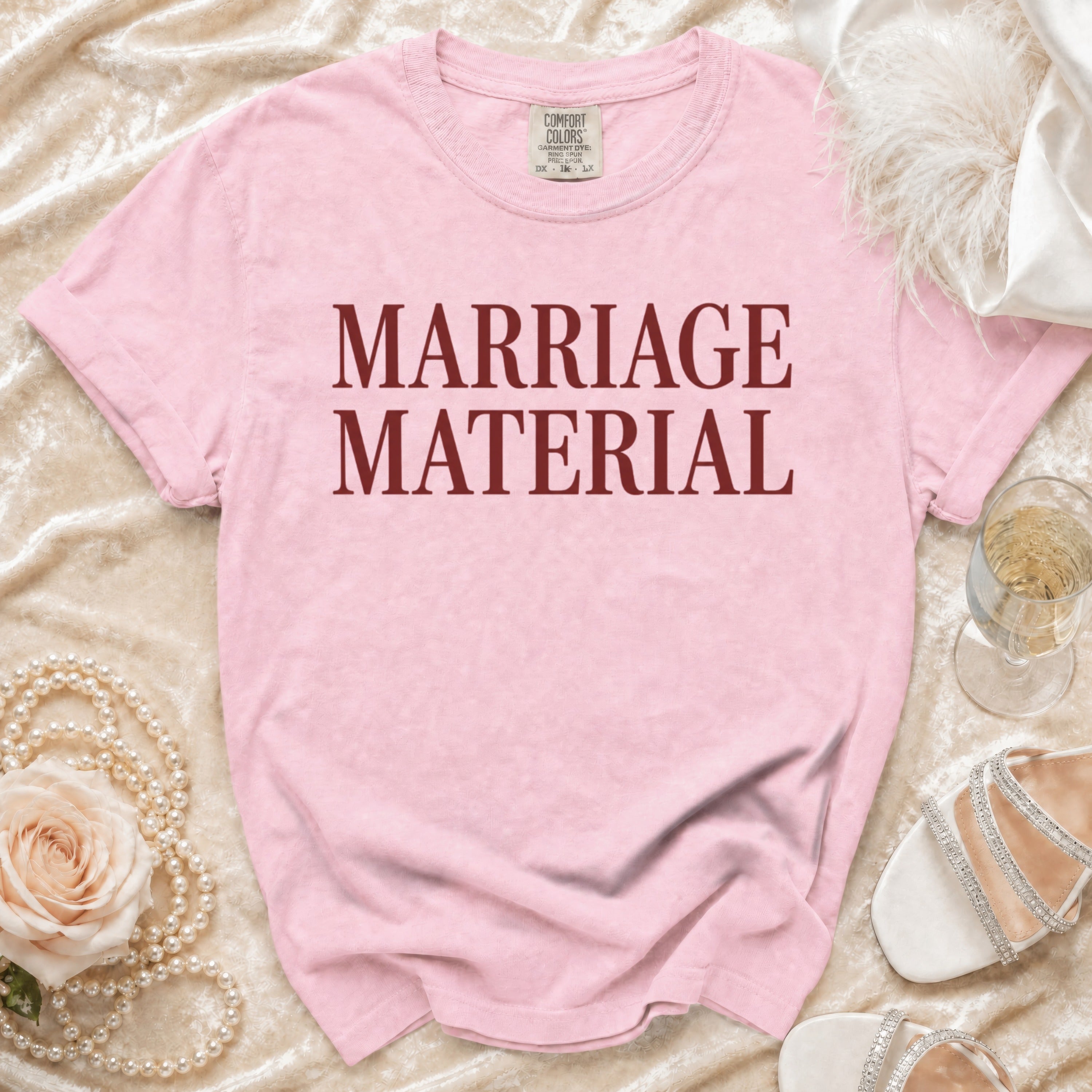 Pink t-shirt with "MARRIAGE MATERIAL" printed in maroon.