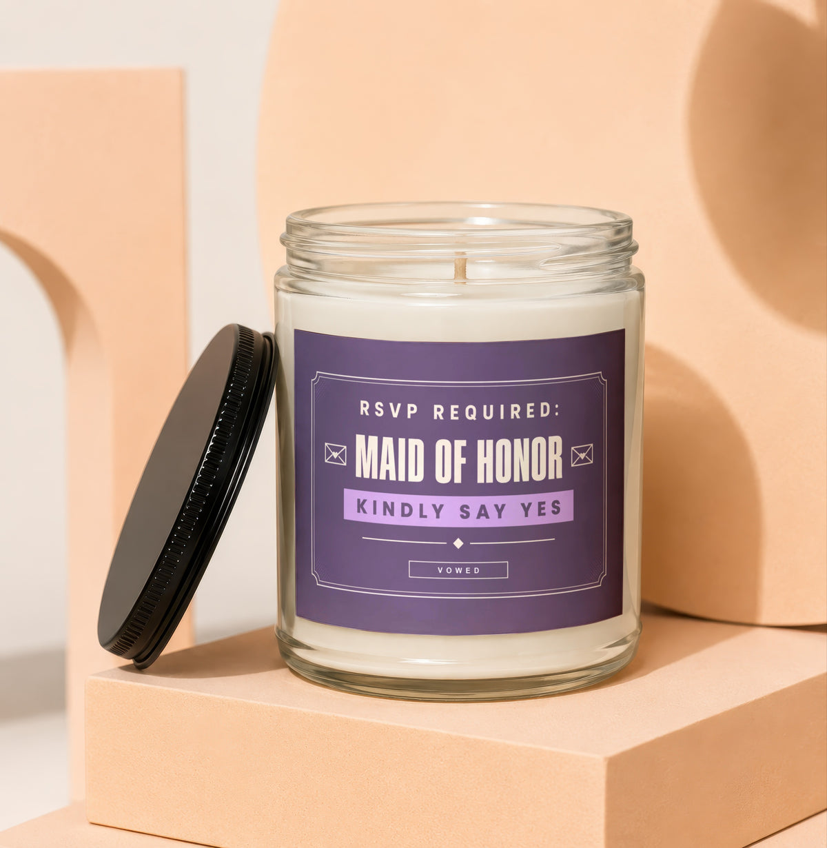 Glass jar candle with "Maid of Honor Kindly Say Yes" text on purple label.