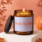 Amber candle with lit flame, reads "Worth The Wait; Just Married, Still Obsessed; Vowed."