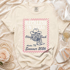 Cream t-shirt with "Reckless in Texas Olivia Bach Austin, TX Summer 2026" text and graphic.