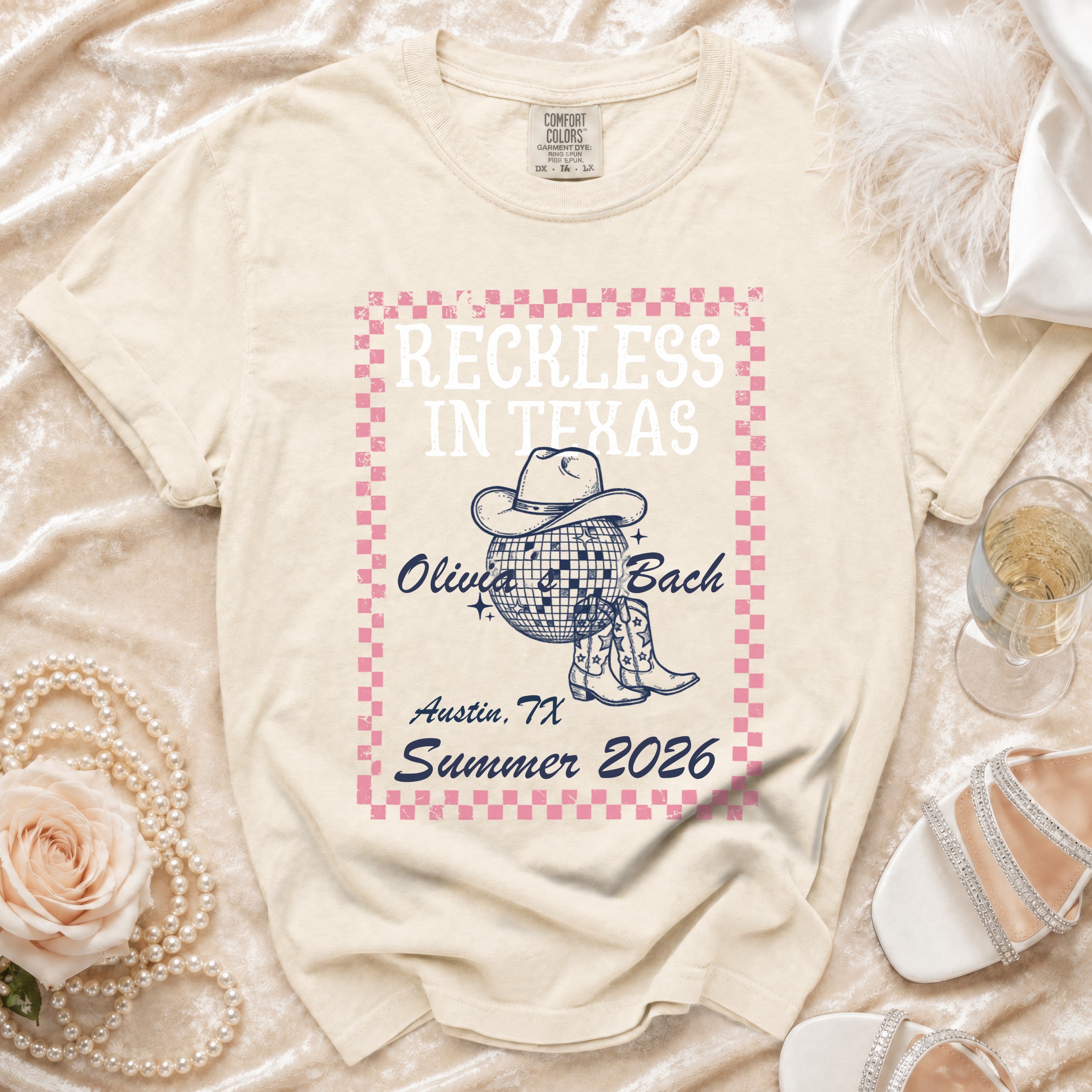 Cream t-shirt with "Reckless in Texas Olivia Bach Austin, TX Summer 2026" text and graphic.