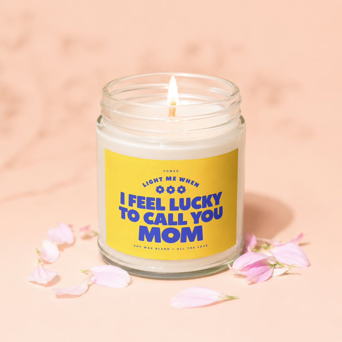 Lit candle in jar with yellow label: "I feel lucky to call you Mom"