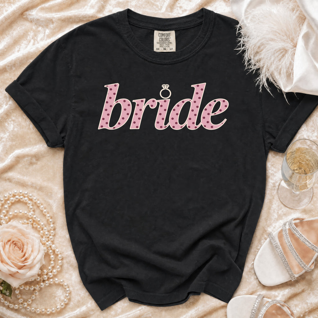 Black t-shirt with "bride" in pink polka dot font and a diamond ring icon.