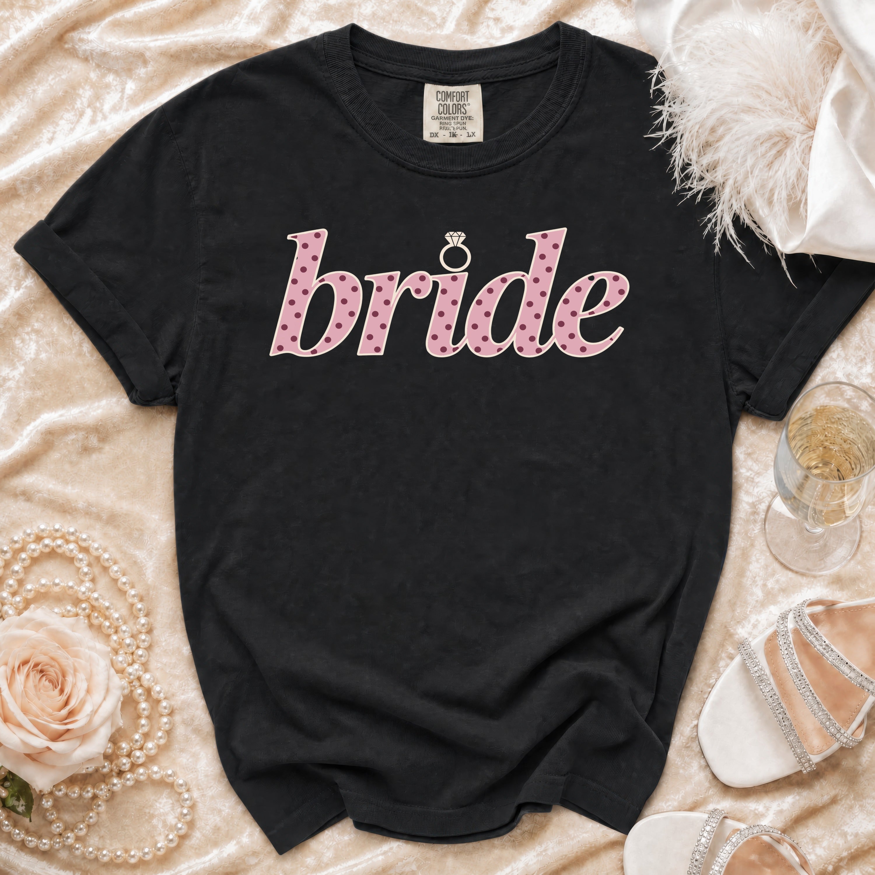 Black t-shirt with "bride" in pink polka dot font and a diamond ring icon.