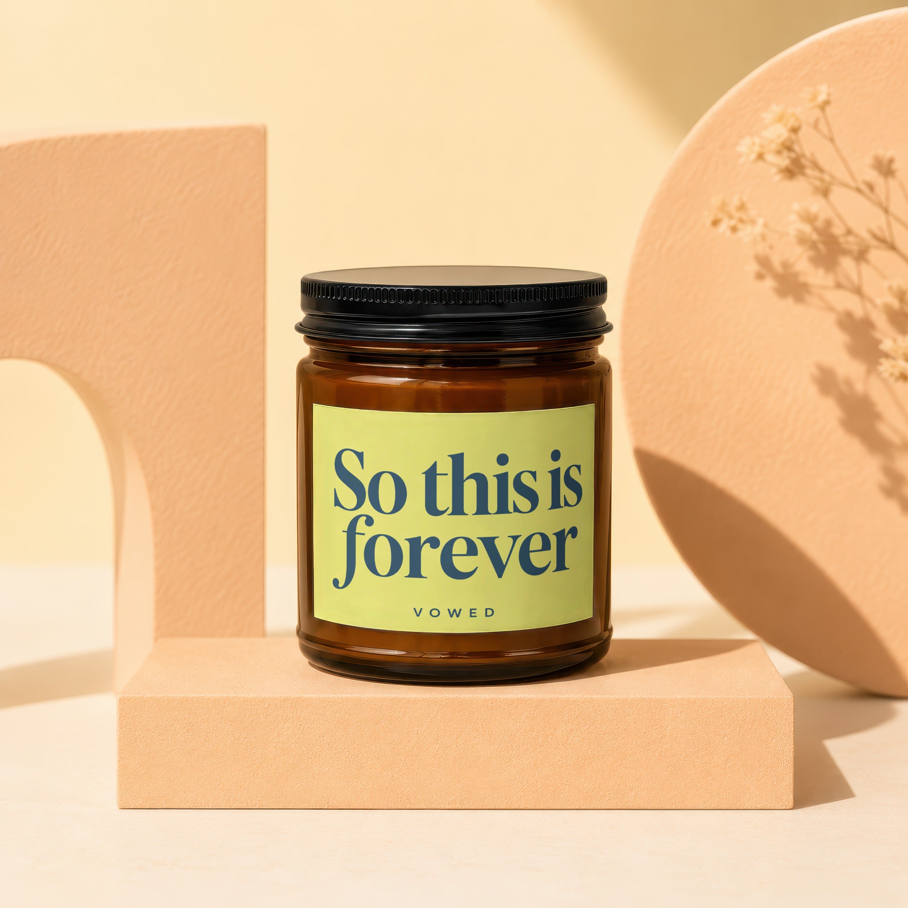 Amber jar candle with light green label reading "So this is forever VOWED".
