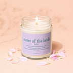 Sister of the Bride candle with descriptive text and petals scattered around.