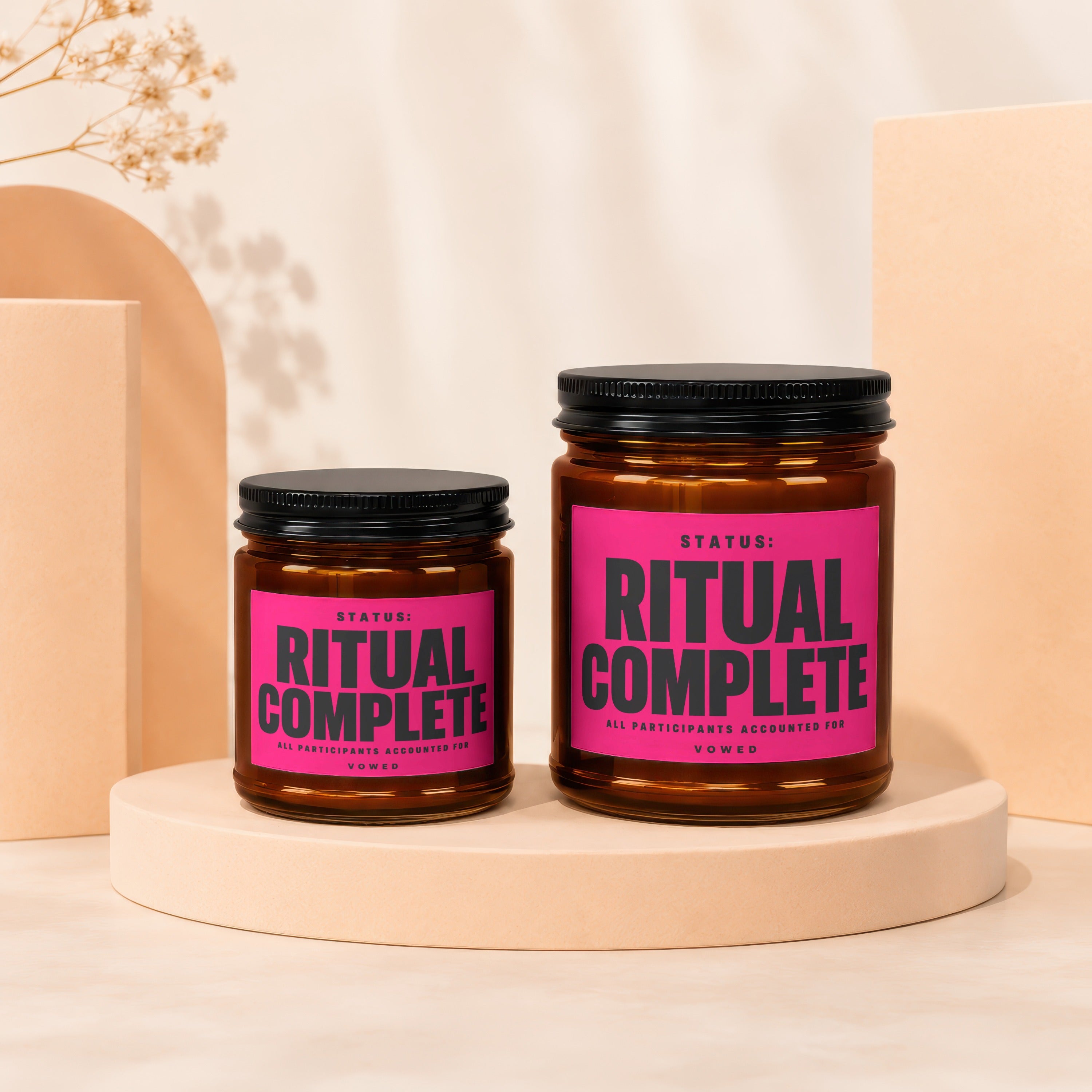 Two amber jars with black lids, one larger than the other, both labeled "Ritual Complete."
