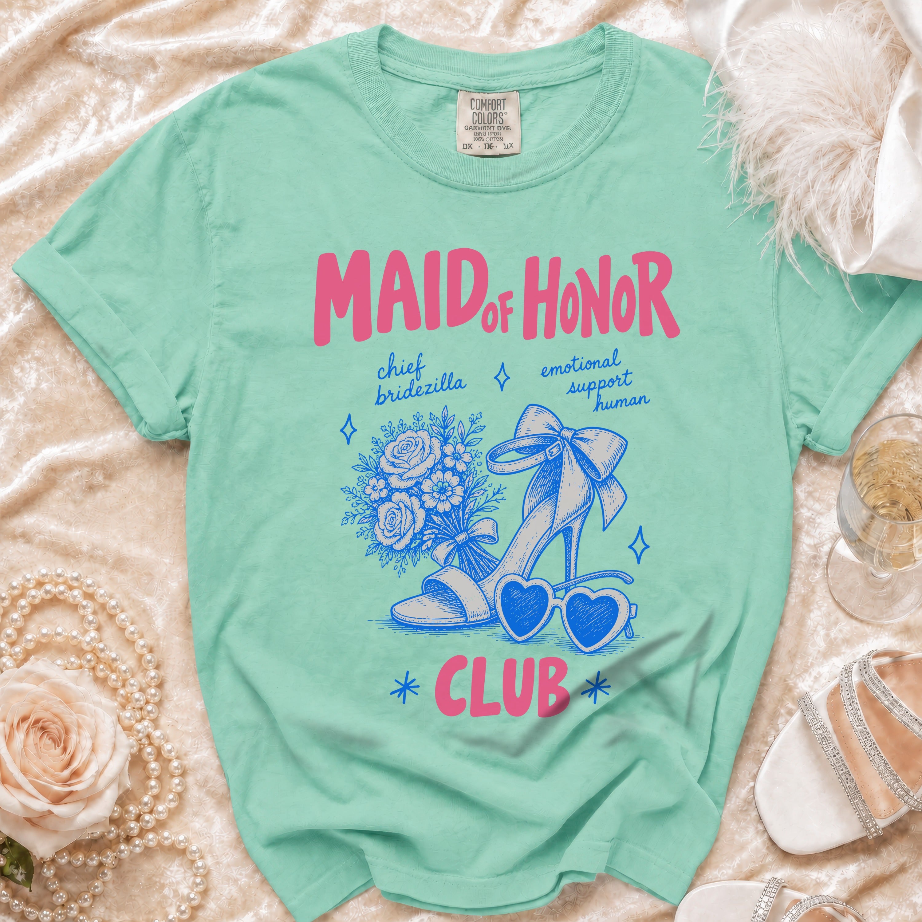 Mint green t-shirt with "Maid of Honor Club" text and graphic elements.
