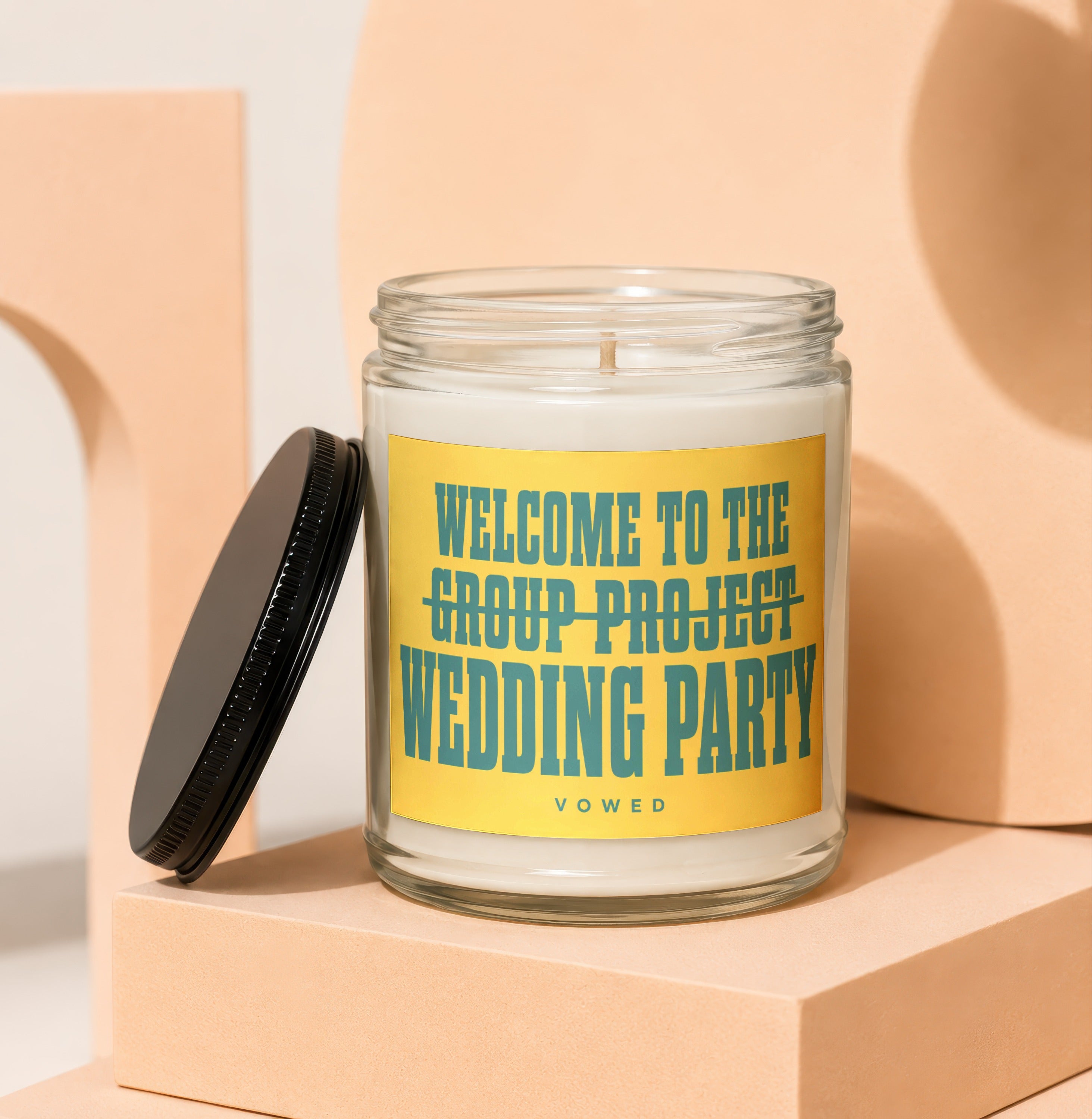 Candle with yellow label reading "Welcome to the Group Project Wedding Party"