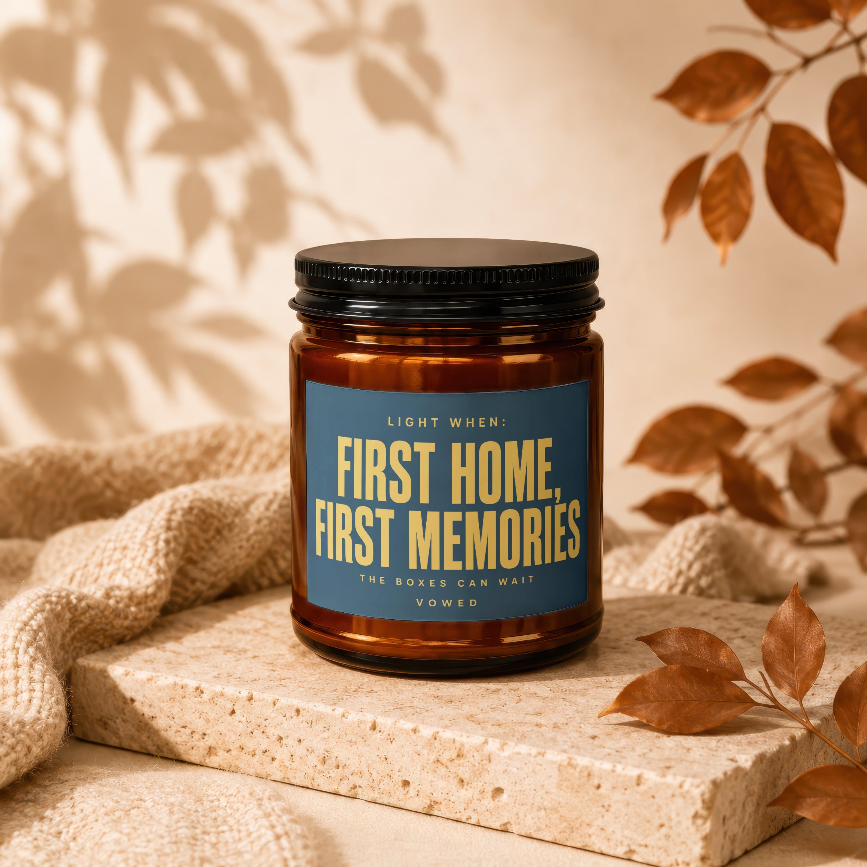 Amber jar candle with blue label reading "First Home, First Memories"