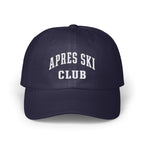 Dark navy blue baseball cap with white embroidered text reading APRES SKI CLUB.