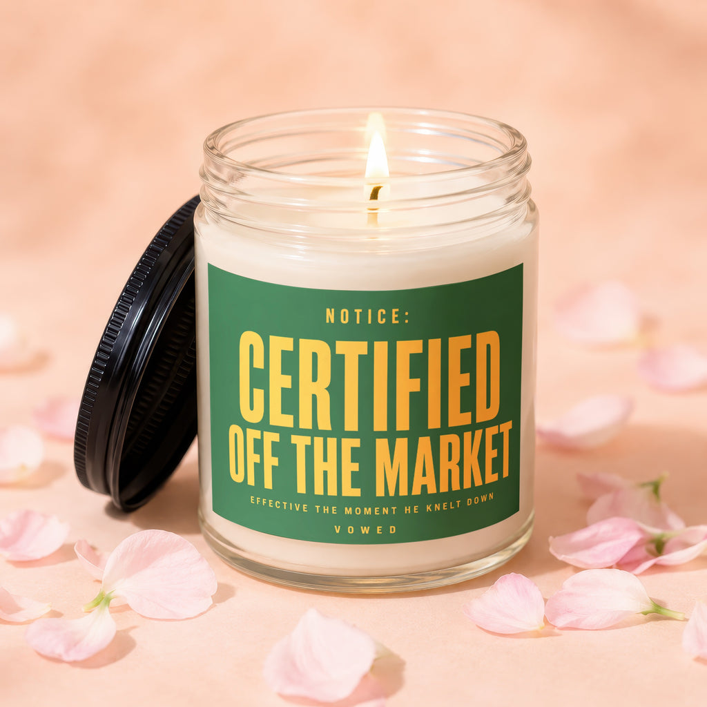 Lit candle in a jar with a green label reading "NOTICE: CERTIFIED OFF THE MARKET".