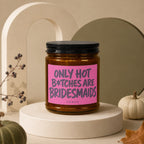 Candle with pink label reading "Only Hot B*tches Are Bridesmaids" from Vowed.