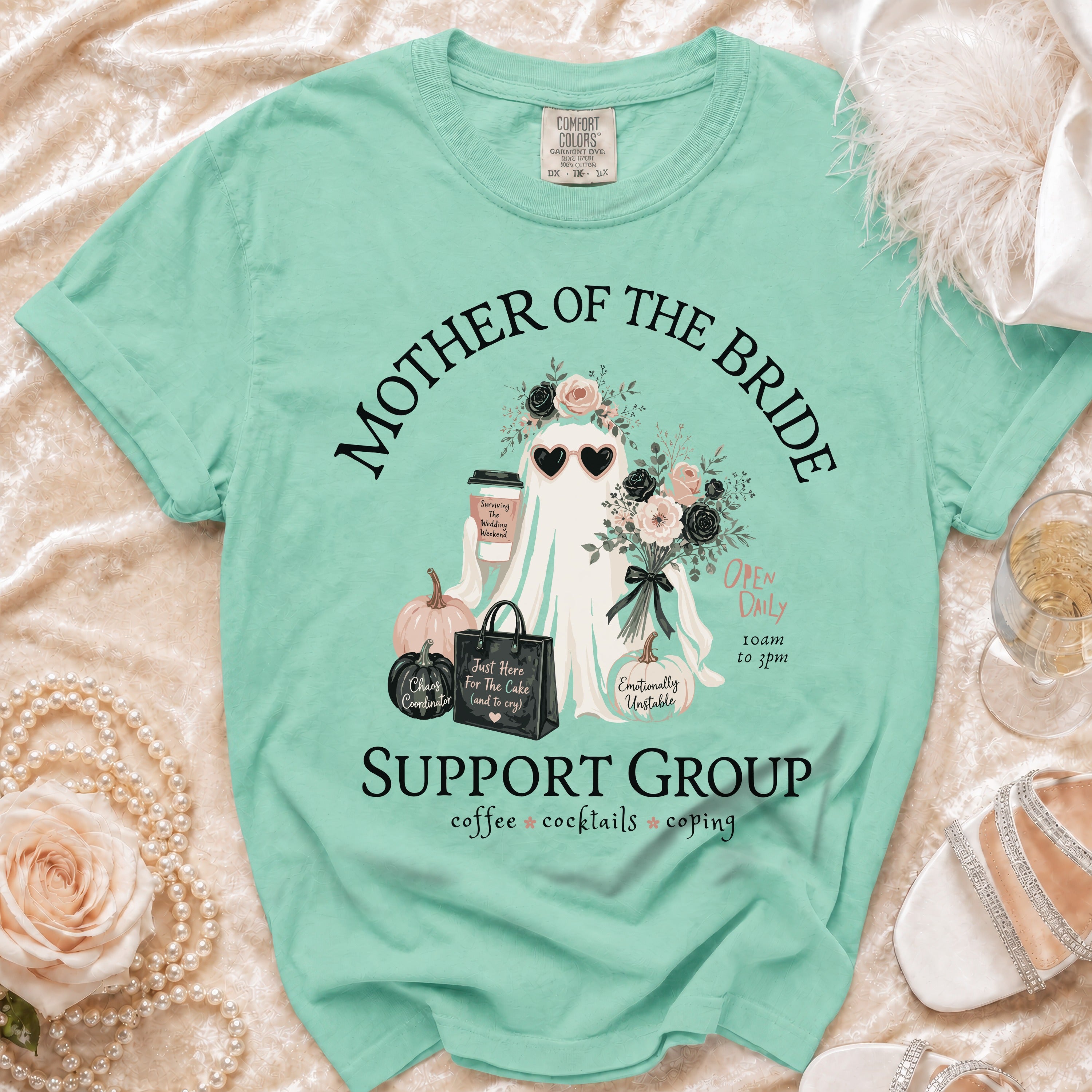 Mint green t-shirt with a ghost wearing heart sunglasses and text "Mother of the Bride Support Group".