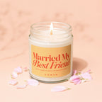 Candle with "Married My Best Friend" and "VOWED" text, surrounded by pink petals.