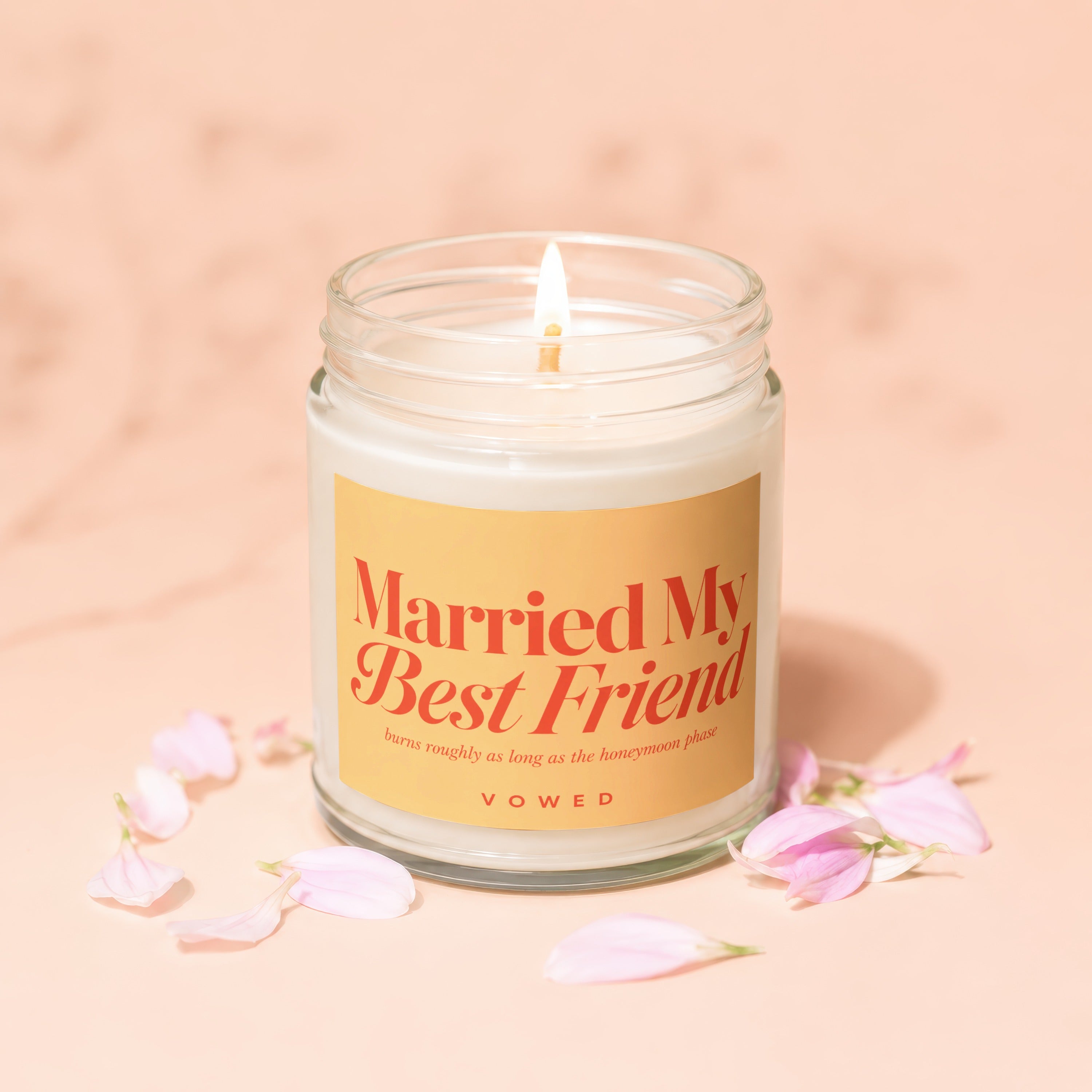Candle with "Married My Best Friend" and "VOWED" text, surrounded by pink petals.