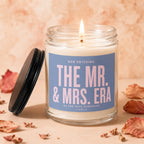 Jar candle with lit flame, label reads "The Mr. & Mrs. Era"