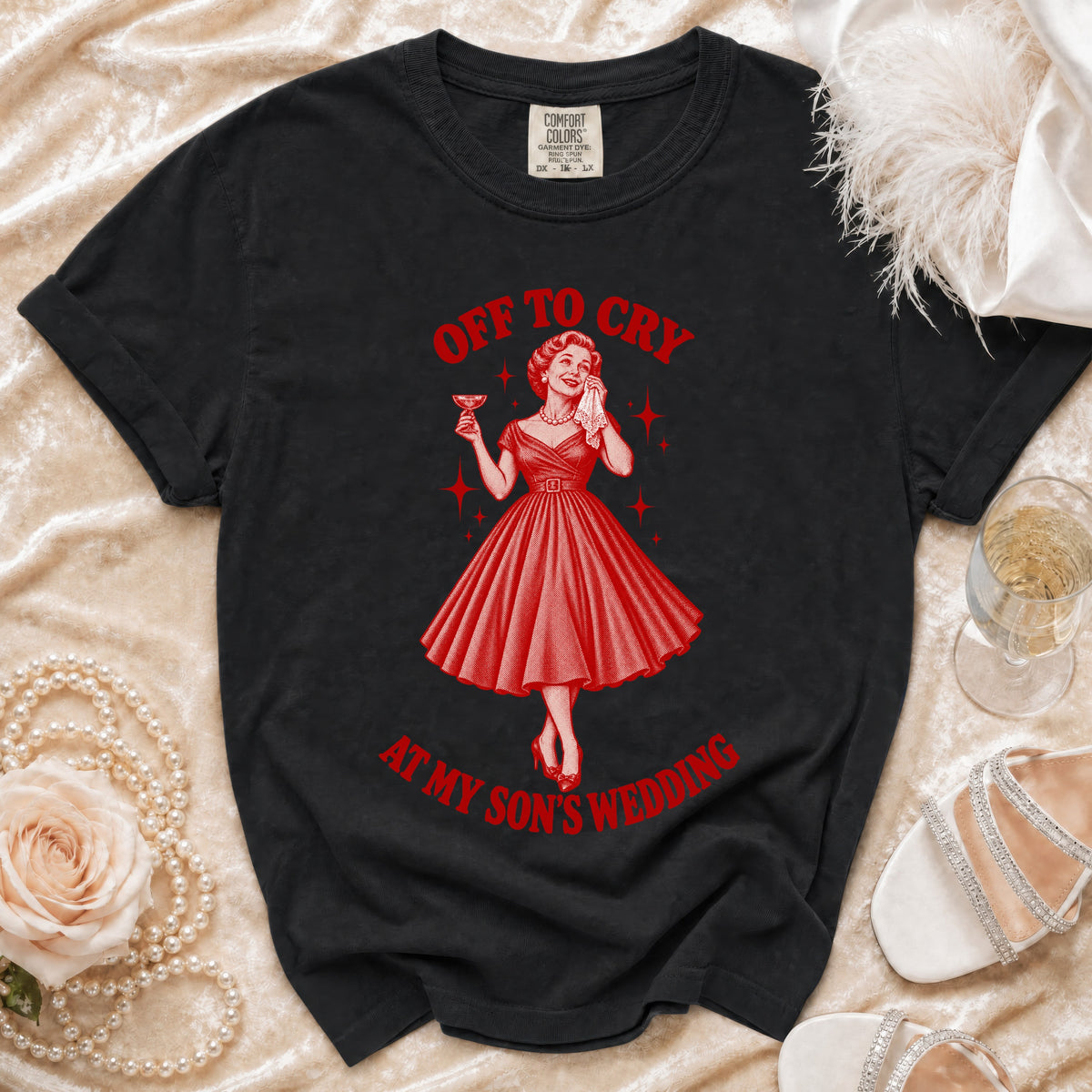 Black t-shirt with red graphic of woman crying with champagne and text "Off to Cry at My Son's Wedding".