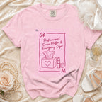 Pink t-shirt with stamp design featuring tissues and lipstick: "Professional Dress Fluffer & Emergency Cryer".