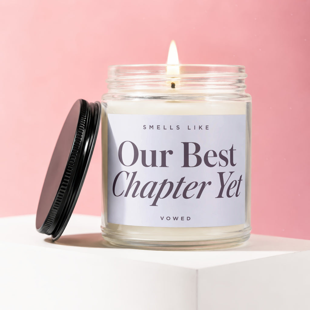 Scented candle with label reading "Smells Like Our Best Chapter Yet"
