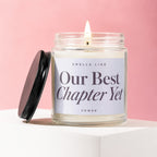 Scented candle with label reading "Smells Like Our Best Chapter Yet"