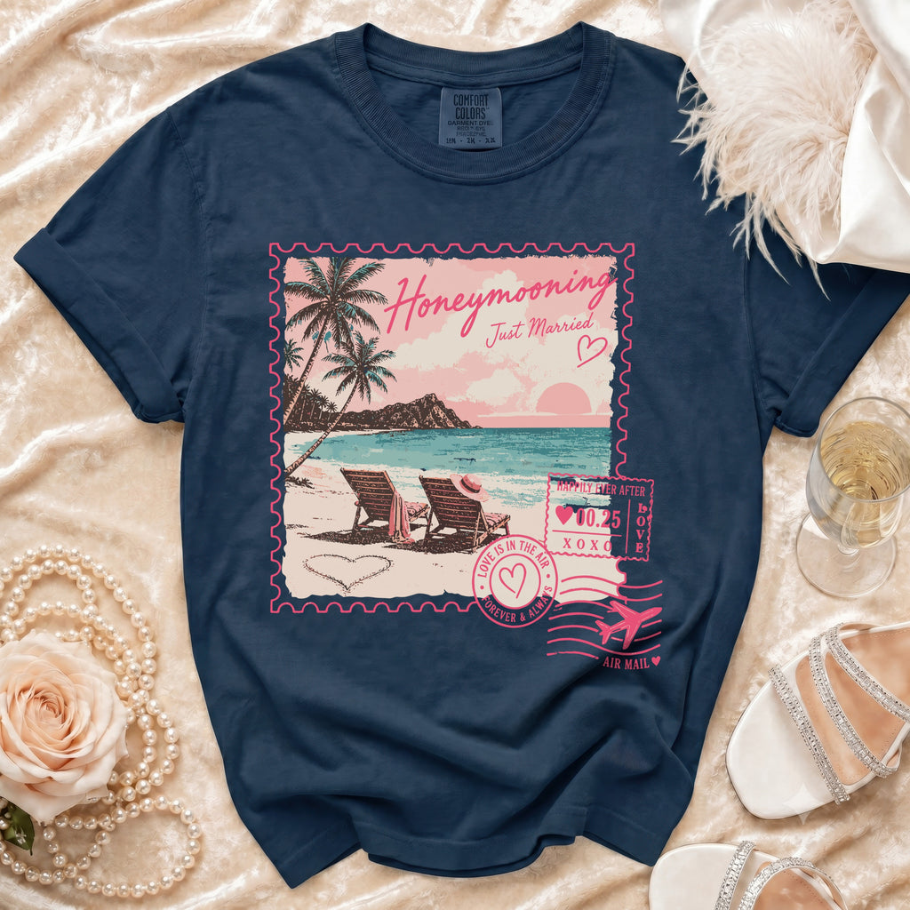 Navy t-shirt with "Honeymooning Just Married" stamp graphic of a beach scene.