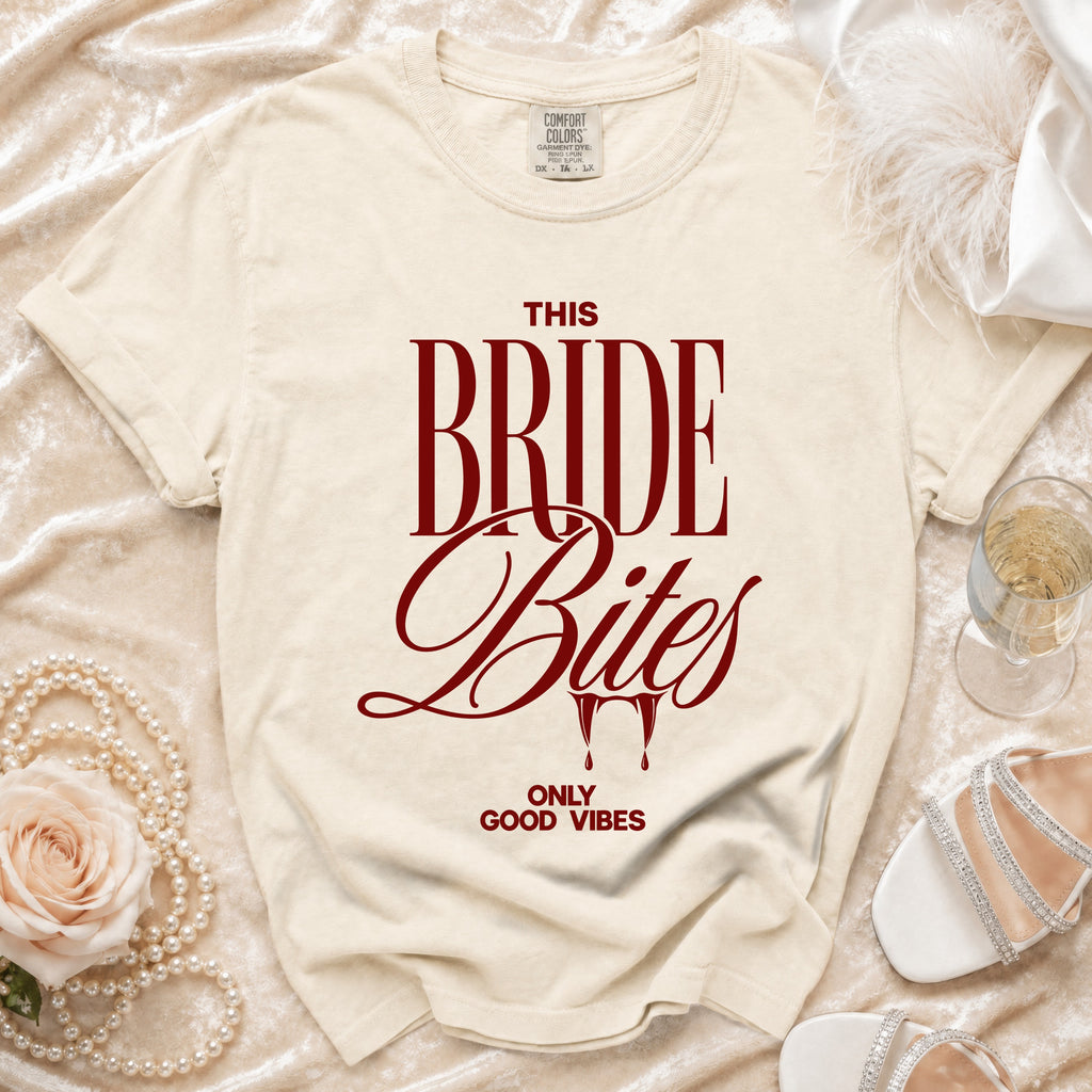 Cream t-shirt with "THIS BRIDE Bites ONLY GOOD VIBES" text in burgundy.