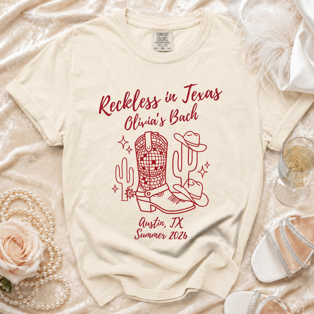 T-shirt with "Reckless in Texas Olivia's Bach Austin, TX Summer 2026" and Western graphics.