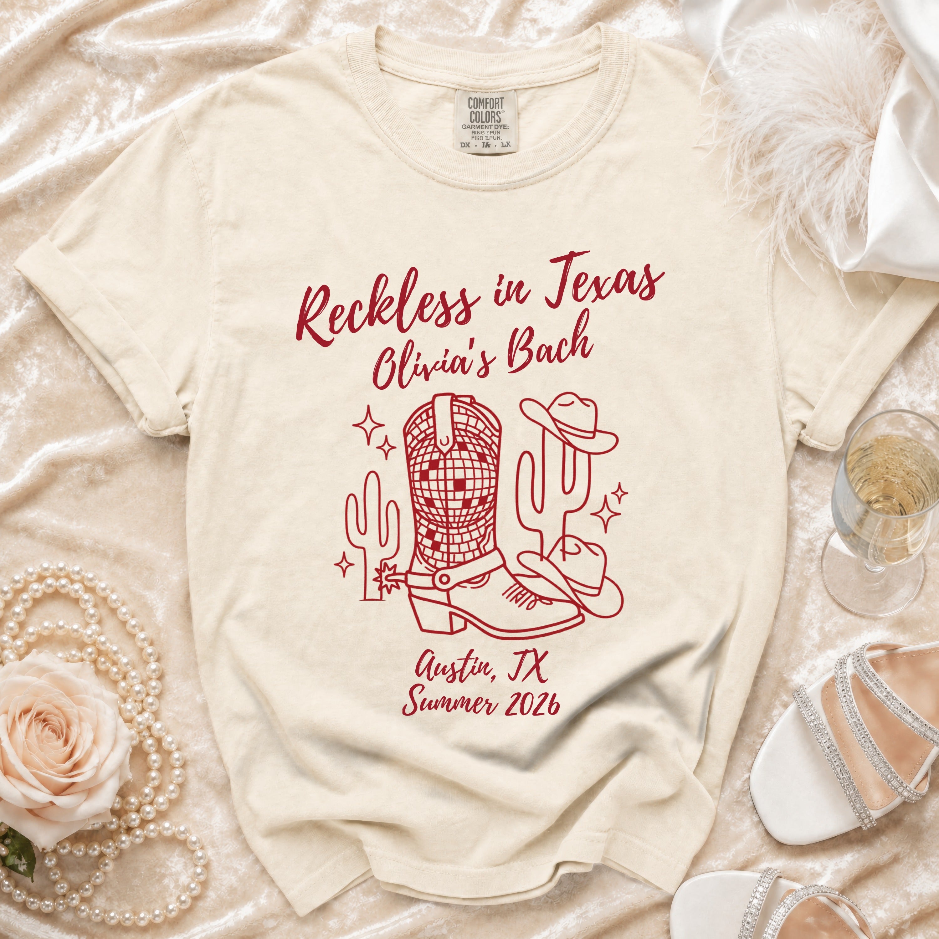 T-shirt with "Reckless in Texas Olivia's Bach Austin, TX Summer 2026" and Western graphics.