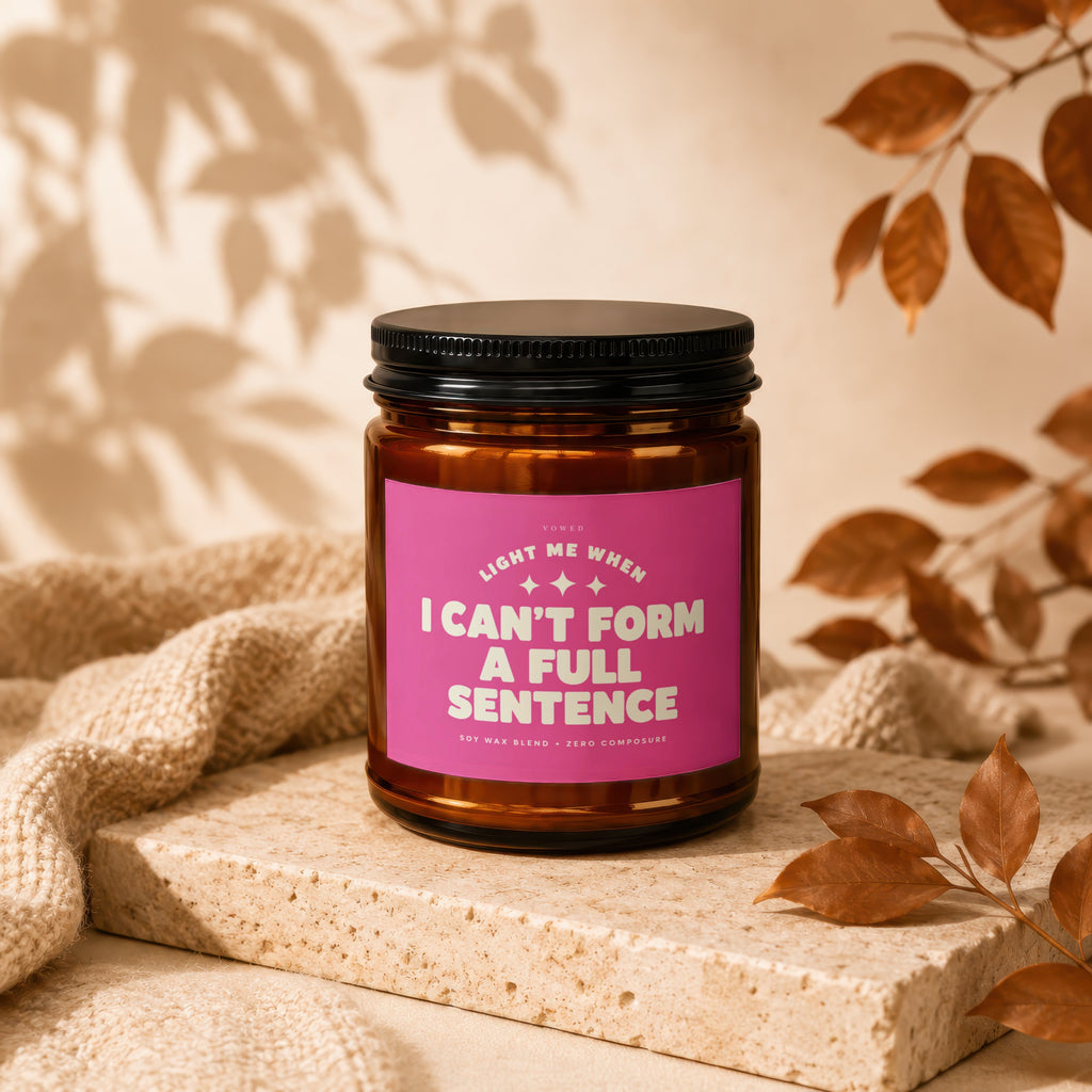 Brown jar candle with black lid and pink label reading "I CAN'T FORM A FULL SENTENCE".