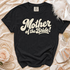 Black t-shirt with "Mother of the Bride!" text in cream.