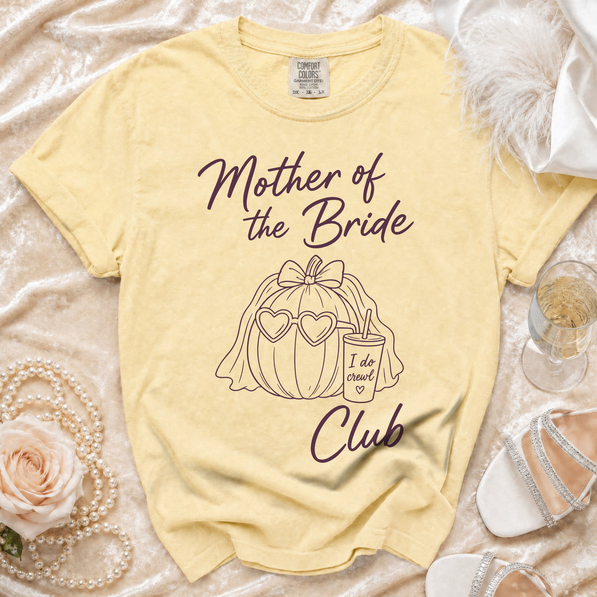 Yellow t-shirt with "Mother of the Bride Club" text and pumpkin graphic.