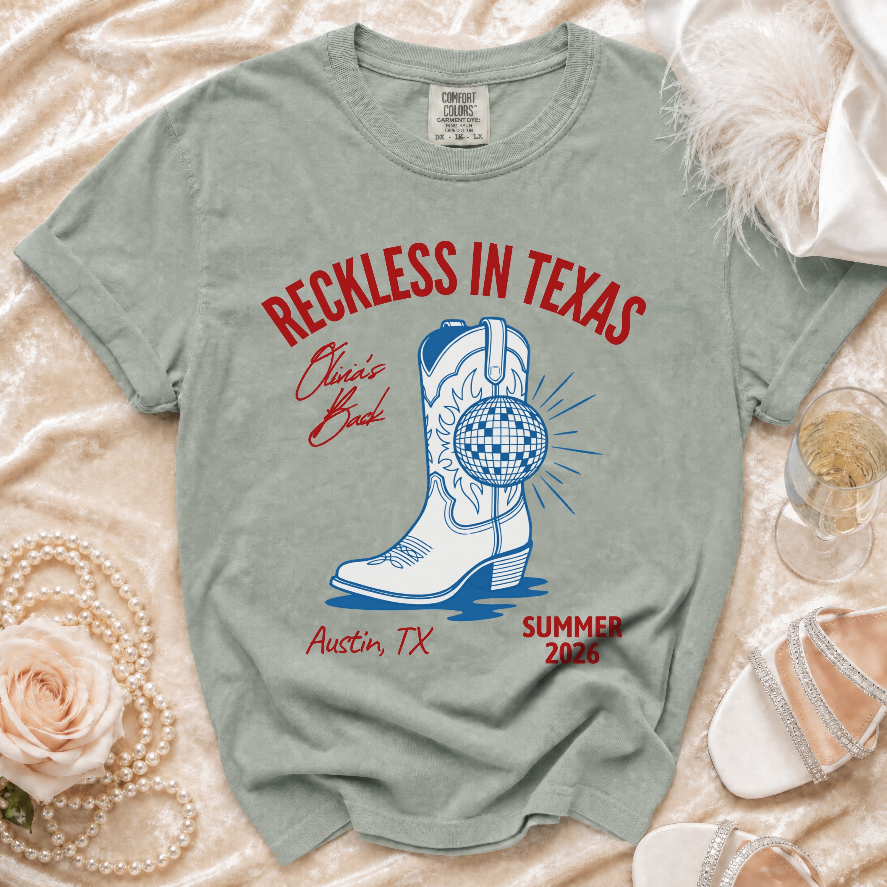 Graphic t-shirt with cowboy boot, disco ball, and text "Reckless in Texas."