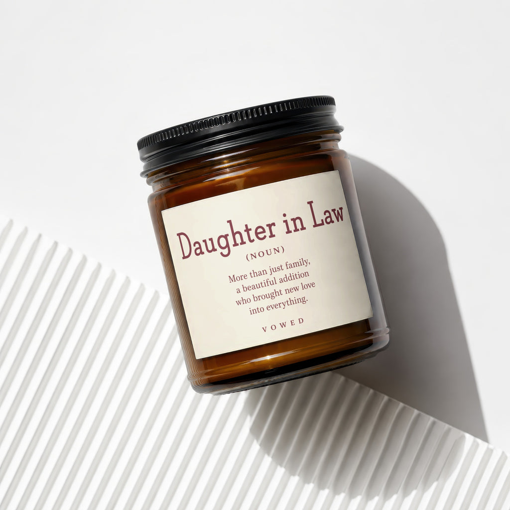Amber candle with "Daughter in Law" definition text on a textured background.