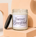 Glass candle with a black lid and label that reads "Smells Like Forever Bewitched".