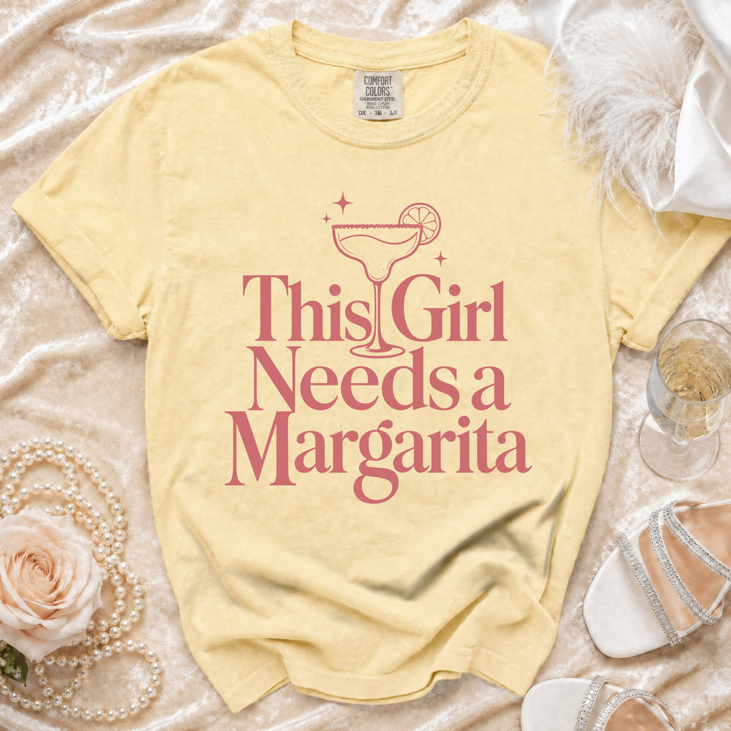 Yellow t-shirt with pink "This Girl Needs a Margarita" graphic and margarita glass.